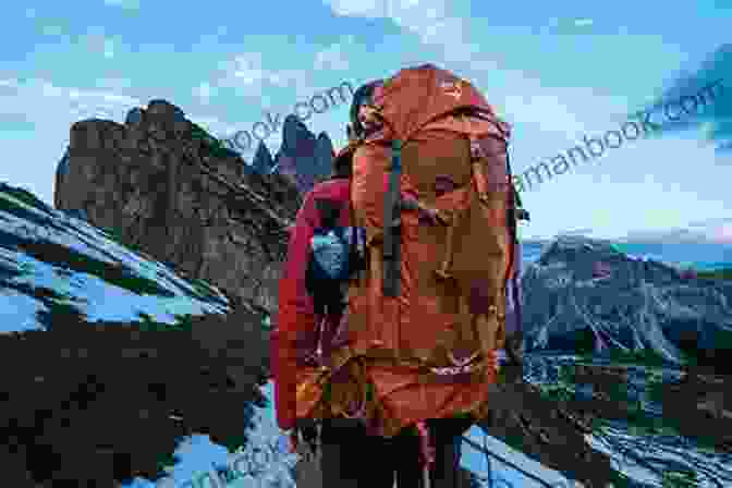 A Hiker Wearing A Minerva Ultralite Crusade Backpack Stands On A Mountain Peak, With A Vast Landscape Stretching Out Behind. Minerva And The Ultralite Crusade